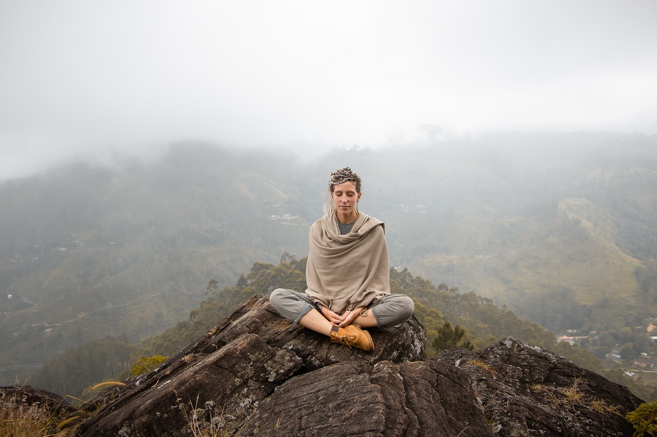 A woman meditating outdoors, symbolizing inner peace and spiritual growth, representing Spiritual Growth Coaching.